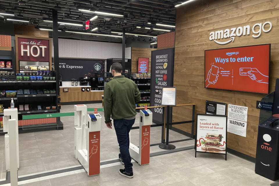 A man uses his smartphone to enter an Amazon Go convenience store in Rockefeller Center in the borough of Manhattan in New York City on Friday, January 28, 2022. (AP Photo/Ted Shaffrey)