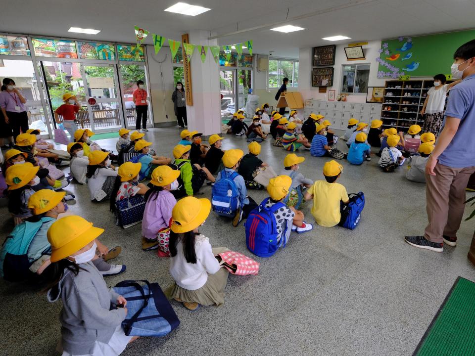 Elementary school students wearing face masks amid concerns over the spread of the COVID-19 coronavirus prepare to leave from their reopened school in Tokyo on June 1, 2020, one week after the Japanese government lifted the state of emergency nationwide.