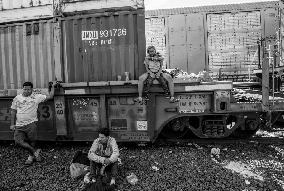 Migrants wait for a train to leave for Ciudad Juárez at a rail yard in Chihuahua City on Sept. 23, 2023. Mexican authorities removed the migrants from the area.