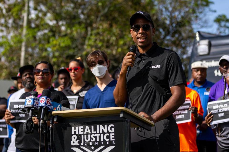 Healing and Justice Center Medical Director Dr. Armen Henderson speaks to the media during a press conference across the street from the scene of a shooting at NW 58th St and NW 7th Court, in Liberty City, Florida, on Thursday, March 14, 2024. City of Miami police officers shot Donald Armstrong last week more than five times while responding to an emergency call during a mental health crisis.