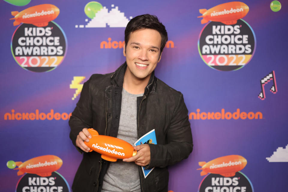 Nathan Kress poses backstage with the award for Favorite Family TV Show at the Nickelodeon's Kids' Choice Awards 2022