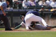 Seattle Mariners pitcher Andres Munoz tags out Oakland Athletics' Luis Barrera at the plate during the seventh inning of a baseball game Wednesday, May 25, 2022, in Seattle. (AP Photo/Ted S. Warren)