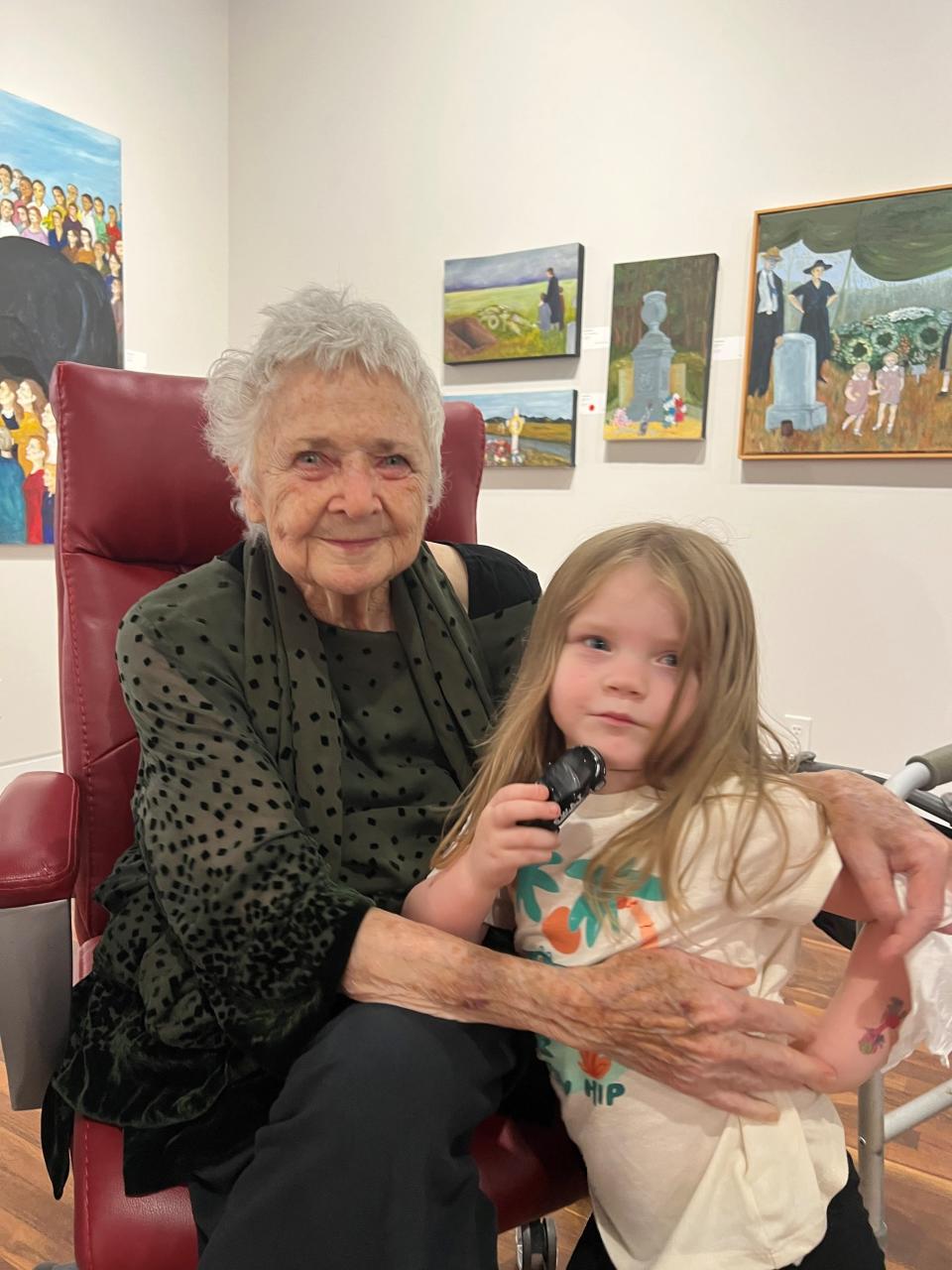 Artist Connie Bostic with great-granddaughter Leona Lyda at Bostic's retrospective exhibition, "Walking Naked in the World,” at Upstairs Artspace in Tyron in 2023.