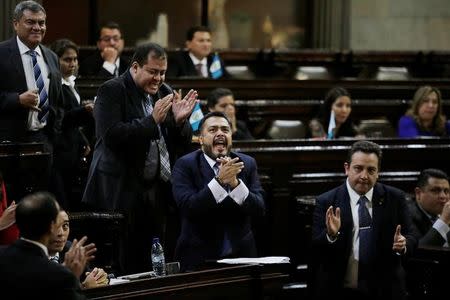 Congress members react after congress voted to preserve President Jimmy Morales's (not pictured) immunity from prosecution, in Guatemala City, Guatemala September 11, 2017. REUTERS/Luis Echeverria