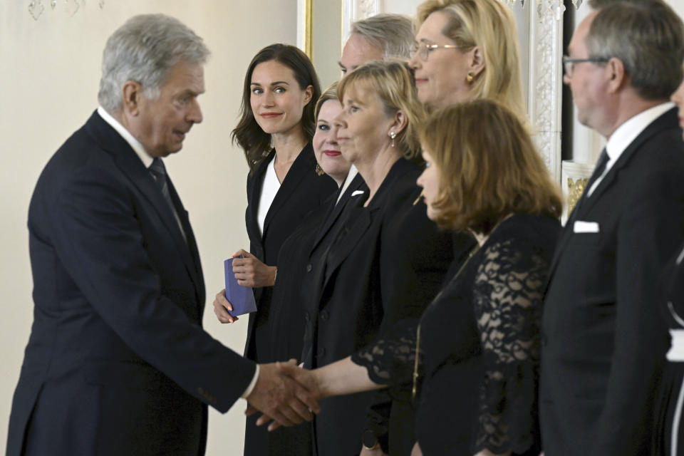 The outgoing government of Finland led by former prime minister Sanna Marin, background center, pays a farewell visit to President of Finland Sauli Niinisto at the Presidential Palace in Helsinki, Finland, Tuesday June 20, 2023. (Jussi Nukari/Lehtikuva via AP)