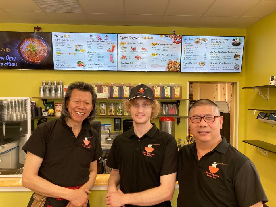 From left to right, manager Ken Cheung, employee Jon Berke and owner Michael Chang stand at the counter Nov. 1, 2023 at Magic Chopsticks Noodle Bar in Burlington.