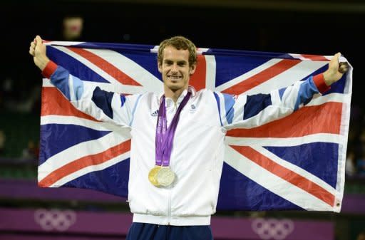 Britain's Andy Murray with his men's tennis singles gold medal on the podium at the London Olympics on August 5. Murray produced the performance of a lifetime to win his first Olympic gold medal with a crushing 6-2, 6-1, 6-4 demolition of world number one Roger Federer in the men's final on Sunday