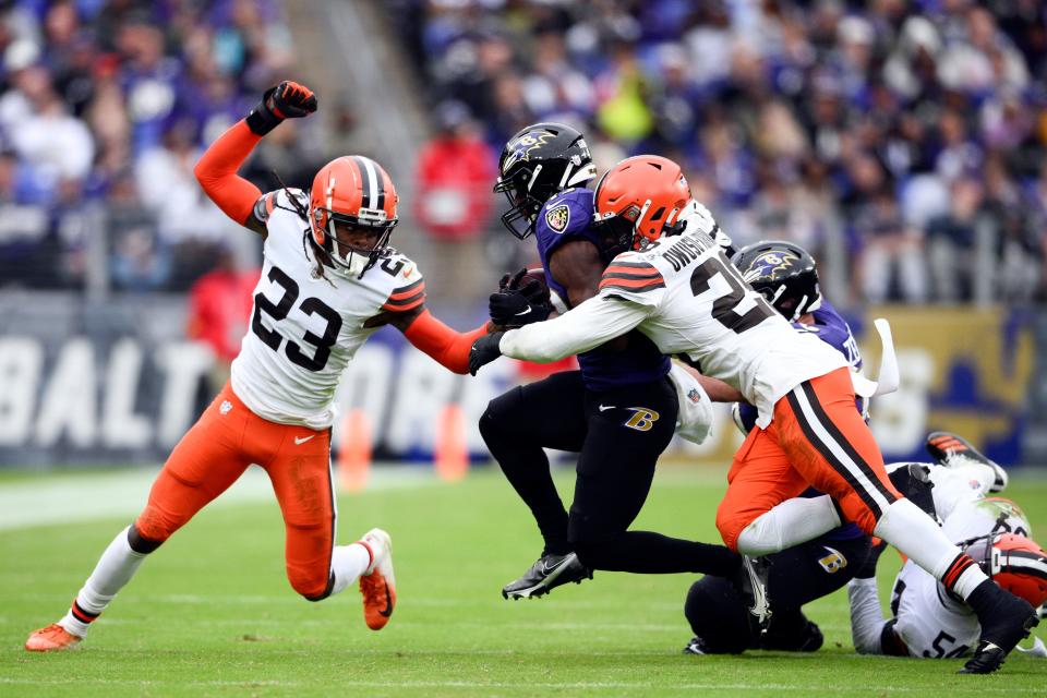 Baltimore Ravens running back Justice Hill Jeremiah Owusu-Koramoah (28) and Martin Emerson Jr. (23) in the second half of an NFL football game, Sunday, Oct. 23, 2022, in Baltimore. (AP Photo/Nick Wass)