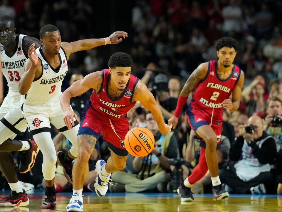 Florida Atlantic guard Bryan Greenlee reaches for the ball ahead of San Diego State guard Micah Parrish during Saturday's semifinal of the Final Four. San Diego State faces UConn in Monday night's championship game.