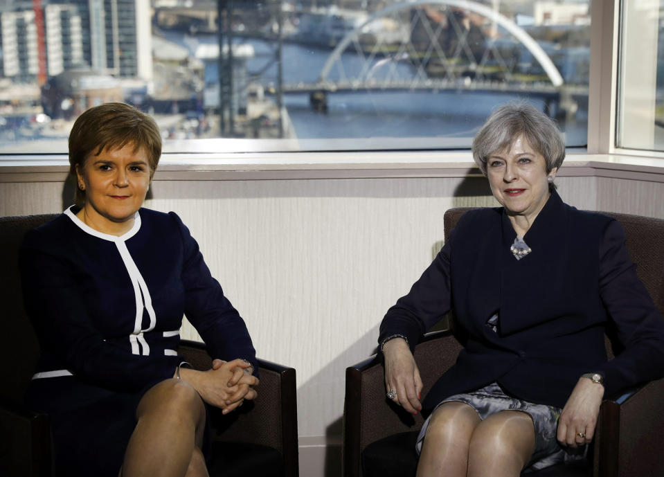 Britain's Prime Minister Theresa May, right, and Scotland's First Minister Nicola Sturgeon sit during their meeting in Glasgow, Scotland, Monday March 27, 2017. May met with Scotland's leader Monday for the first time since they faced off in a struggle over a new push for Scottish independence as the U.K. leaves the European Union. (Russell Cheyne/ PA via AP)