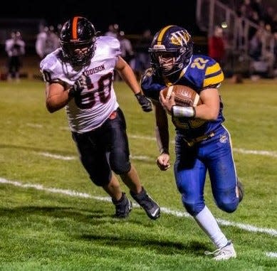 Whiteford's Brandon Knaggs is chased by Gabe Pepper of Addison during a 64-22 Whiteford playoff victory Friday night.
