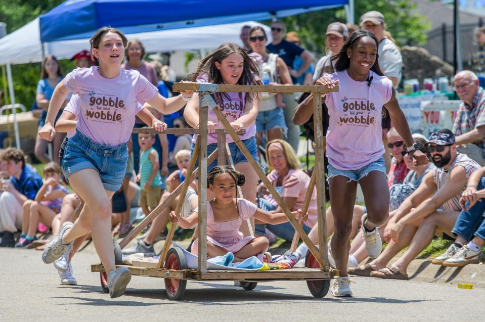 The Miss Tremont team sprints up James Street as they compete in the annual Tremont Turkey Festival bed races Saturday, June 10, 2023 in Tremont.