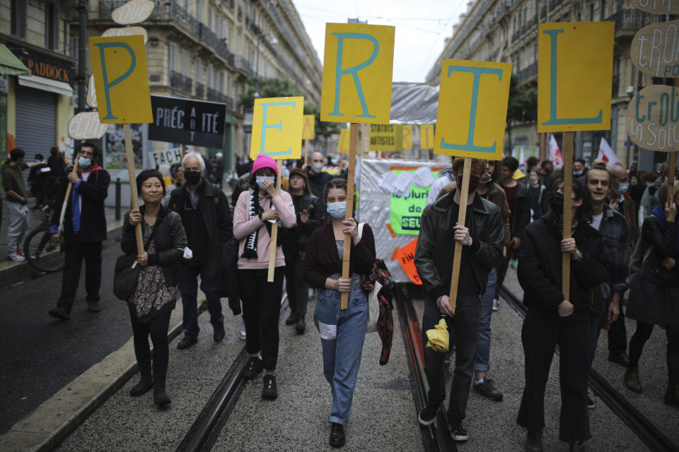 Workers demonstrate with placards reading "Peril" on May Day in Marseille, southern France, Saturday, May 1, 2021. (AP Photo/Daniel Cole)