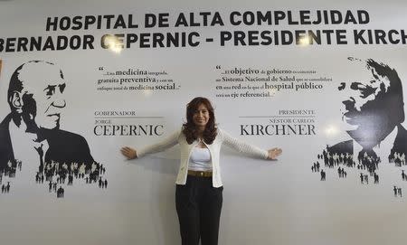 Argentina's President Cristina Fernandez de Kirchner poses in front of a wall with the names of her late husband Nestor Kirchner and late former governor of Santa Cruz province Jorge Cepernic, after she inaugurated a new high complexity hospital in the Patagonian city of El Calafate February 15, 2015. REUTERS/Argentine Presidency/Handout via Reuters