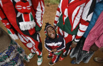 <p>Joseph Njoroge Kimani, 3, stands with his father James Kimani Njoroge, left, and mother Esther Wanjiru Njoroge, right, all wearing suits made in the colors of the Kenyan flag, as they queue to cast their votes in Gatundu, north of Nairobi, in Kenya Tuesday, Aug. 8, 2017. (Photo: Ben Curtis/AP) </p>