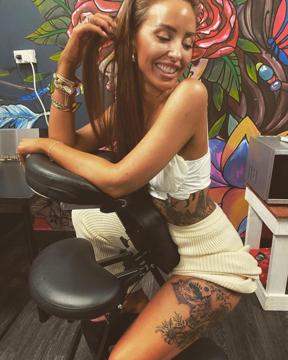 Lizzie Sobinoff in a tattoo parlour chair