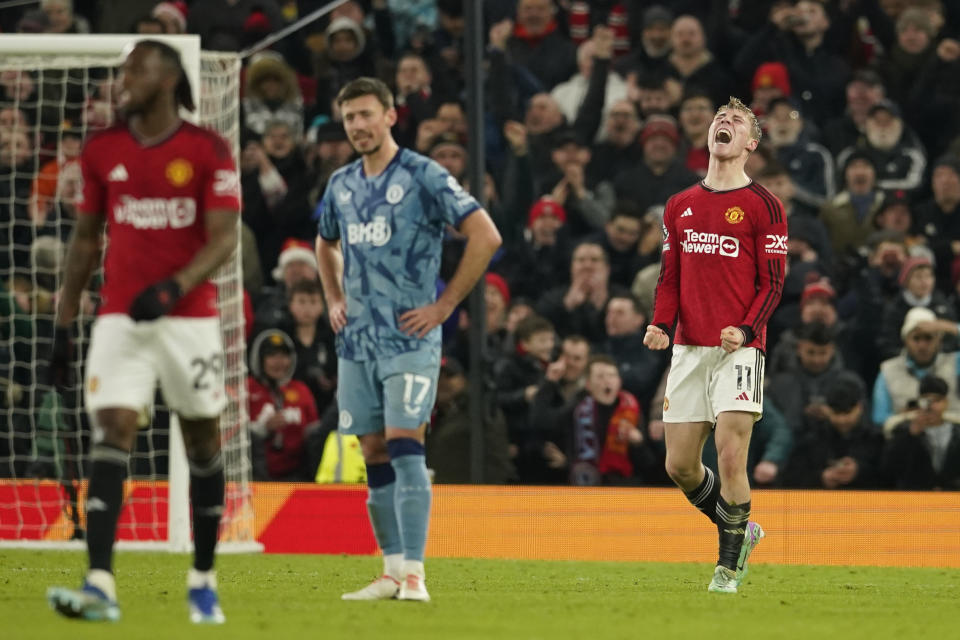 Manchester United's Rasmus Hojlund, right, celebrates after scoring his side's third goal during the English Premier League soccer match between Manchester United and Aston Villa at the Old Trafford stadium in Manchester, England, Tuesday, Dec. 26, 2023. (AP Photo/Dave Thompson)