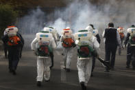 Firefighters disinfect a square against the new coronavirus, in western Tehran, Iran, Friday, March 13, 2020. The new coronavirus outbreak has reached Iran's top officials, with its senior vice president, Cabinet ministers, members of parliament, Revolutionary Guard members and Health Ministry officials among those infected. The vast majority of people recover from the new coronavirus. According to the World Health Organization, most people recover in about two to six weeks, depending on the severity of the illness. (AP Photo/Vahid Salemi)