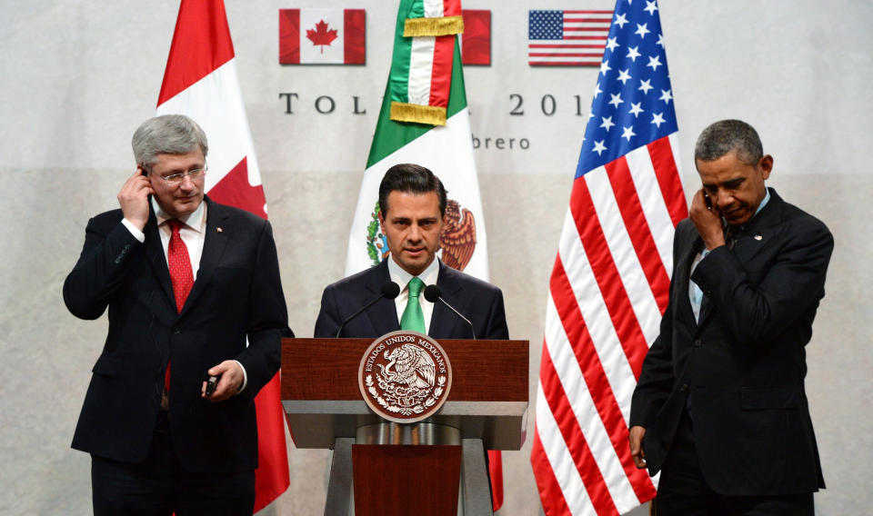 Canada's Prime Minister Stephen Harper, left, and President Barack Obama, right, look on as Mexico's President Enrique Pena Nieto speaks at a news conference during the North American Leaders Summit in Toluca, Mexico, Wednesday, Feb. 19, 2014. Obama is in Toluca for a one-day summit with Mexican and Canadian leaders, meeting on issues of trade and other neighbor-to-neighbor interests, even as Congress is pushing back against some of his top cross-border agenda items. (AP Photo/The Canadian Press, Sean Kilpatrick )