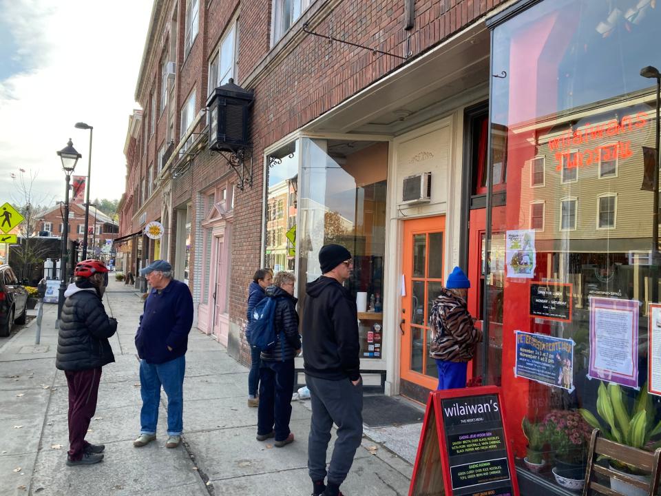 Takeout customers wait for their lunch orders Nov. 3, 2023 outside Wilaiwans in Montpelier.