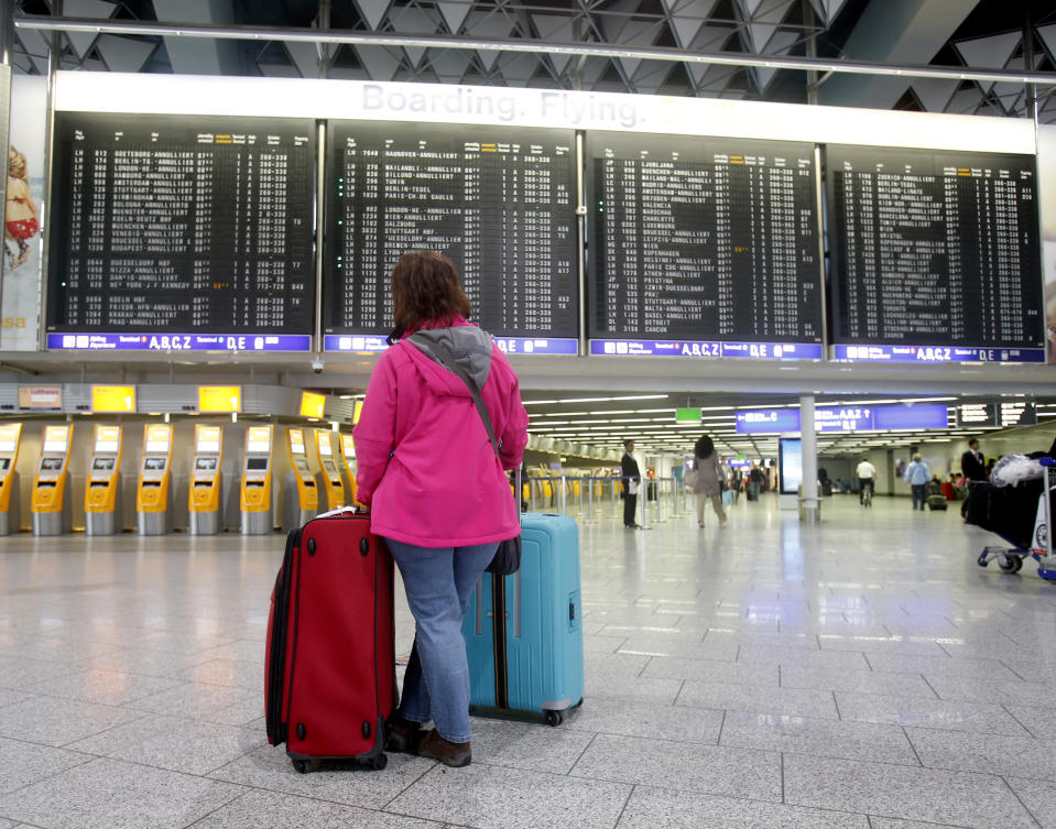 A passenger stands in the terminal at the Frankfurt airport as Lufthansa pilots went on a three-day strike in Frankfurt, Germany, Wednesday, April 2, 2014. Germany's Lufthansa said it has canceled almost 900 domestic and intercontinental flights on the first day of a three-day strike by the pilots' union. Airline spokeswoman Barbara Schaedler said that up to 900 flights were canceled for Wednesday and that it expects to cancel about 3,800 flights altogether, affecting more than 425,000 passengers. (AP Photo/Michael Probst)