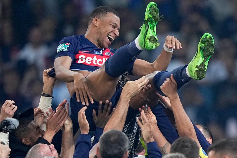 Mbappe is tossed in the air as PSG celebrate winning the French Cup in his last game (AP)