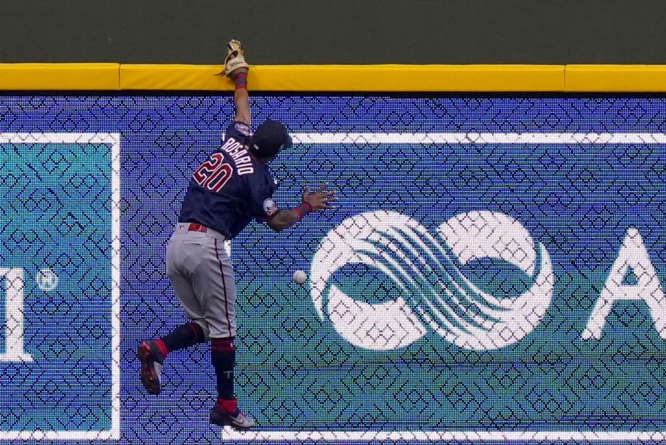 Minnesota Twins left fielder Eddie Rosario can't catch a double hit by Milwaukee Brewers' Orlando Arcia during the second inning of a baseball game Monday, Aug. 10, 2020, in Milwaukee. (AP Photo/Morry Gash)