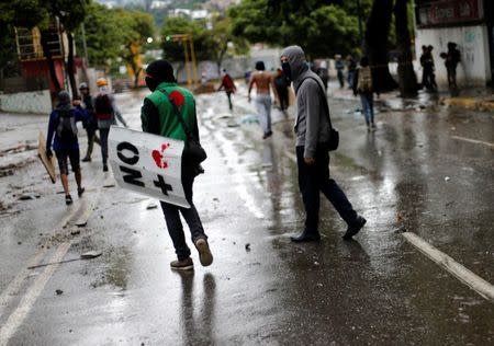 Demonstrators look on while clashing with riot security forces during a rally against Venezuela's President Nicolas Maduro's government in Caracas, Venezuela, July 28, 2017. REUTERS/Andres Martinez Casares