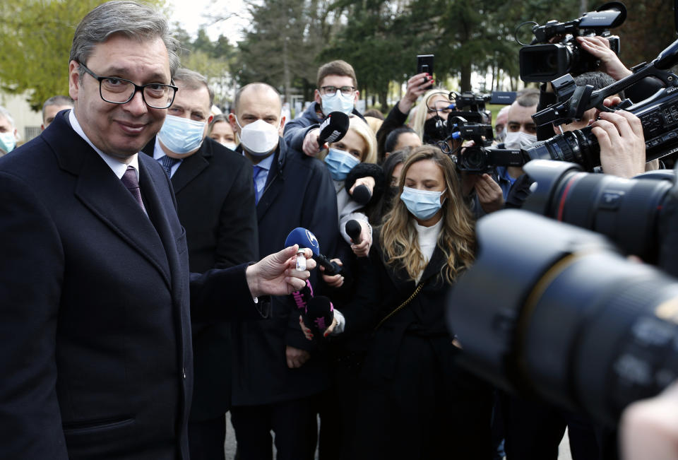 Serbian President Aleksandar Vucic poses with a vial of the Sputnik V in Belgrade, Serbia, Thursday, April 15, 2021. Serbia has announced it will begin packing and later producing Russia's Sputnik V coronavirus vaccine, which would make it the first European state outside Russia and Belarus to begin manufacturing the jab. (AP Photo/Darko Vojinovic)