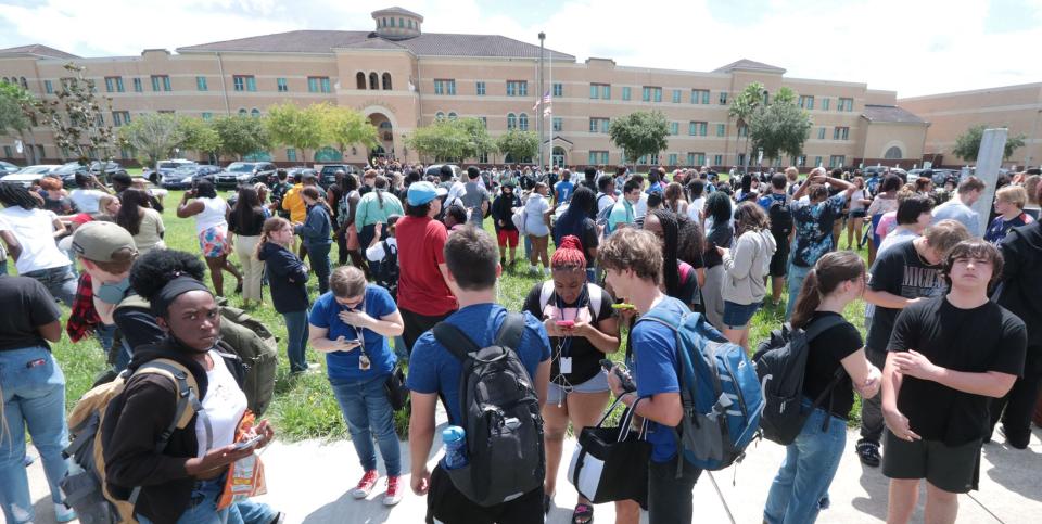 Mainland High School students gather on the front lawn of the campus after being evacuated due to a possible gun threat last year.