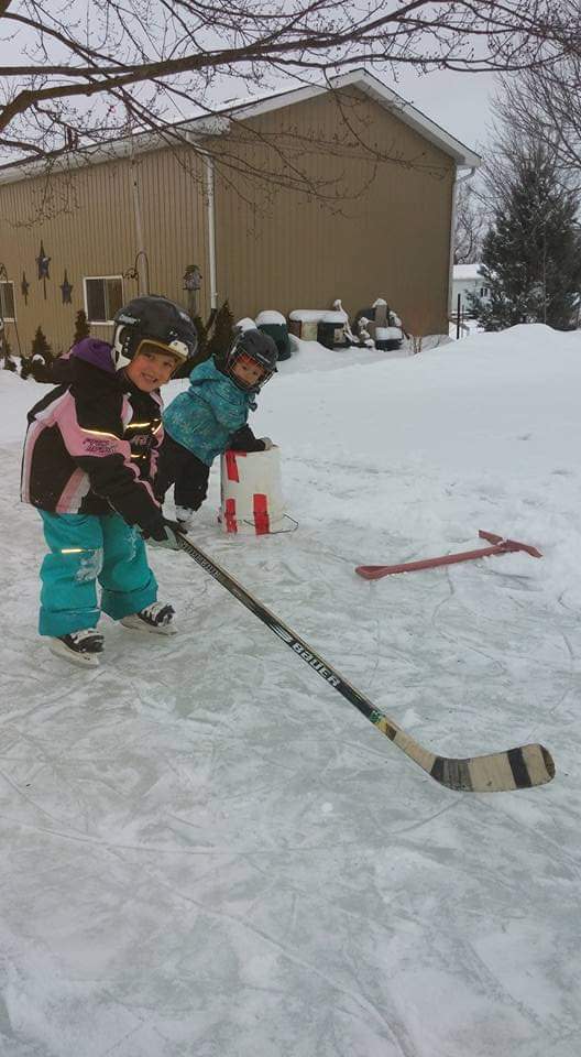 Dunham's "Blue Ice" Team. Each year Dunham would build a skating rink for his daughters, Reydian and Atlin. Image via Krista Lambier. 