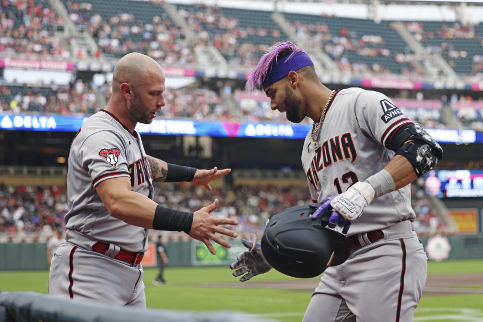 Arizona Diamondbacks' Lourdes Gurriel Jr., right, celebrates with Christian Walker after Gurriel hit a home run against the Minnesota Twins during the second inning of a baseball game Friday, Aug. 4, 2023, in Minneapolis. (AP Photo/Stacy Bengs)