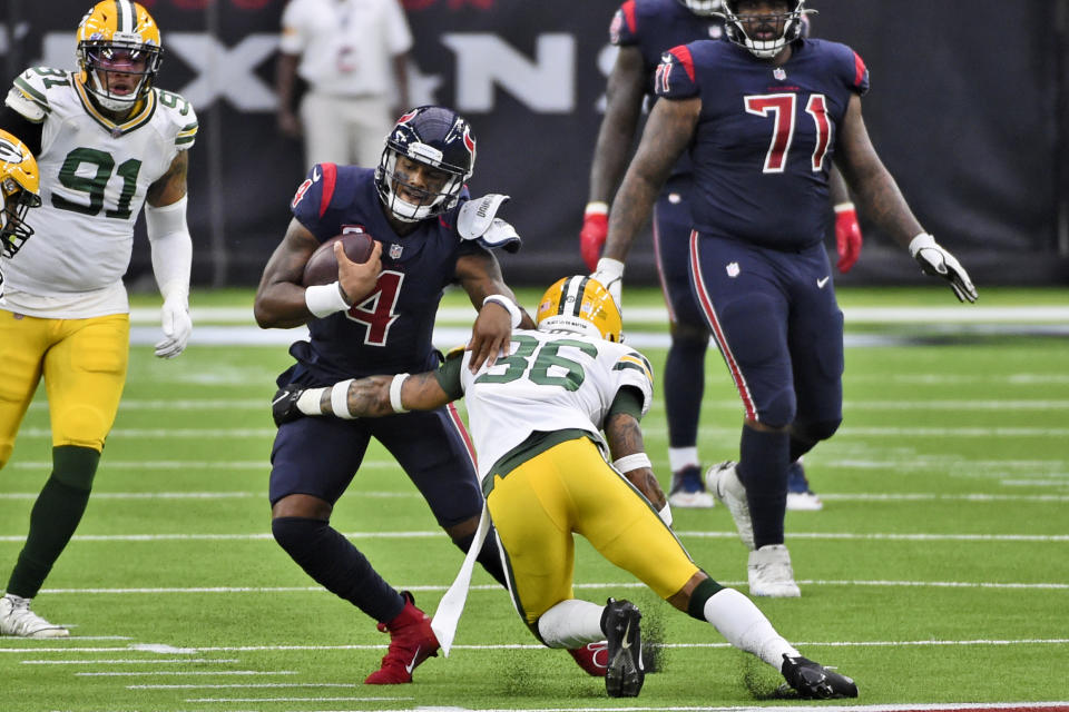 Houston Texans quarterback Deshaun Watson (4) runs with the ball as Green Bay Packers safety Vernon Scott (36) defends during the second half of an NFL football game Sunday, Oct. 25, 2020, in Houston. (AP Photo/Eric Christian Smith)