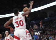 Brooklyn Nets guard Dennis Schroder (17) drives to the net past Toronto Raptors guard Ochai Agbaji (30) during the second half of an NBA basketball game in Toronto, Monday, March 25, 2024. (Nathan Denette/The Canadian Press via AP)