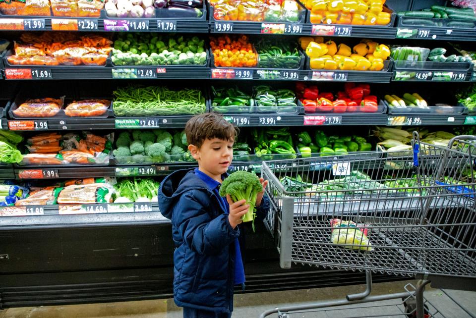 Oliver Reid, 5, shops for produce with his mother, Mollie Reid, in Oklahoma City.