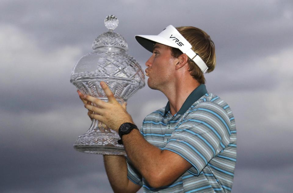 Russell Henley kisses the trophy after winning the Honda Classic golf tournament, Sunday, March 2, 2014 in Palm Beach Gardens, Fla. (AP Photo/Wilfredo Lee)