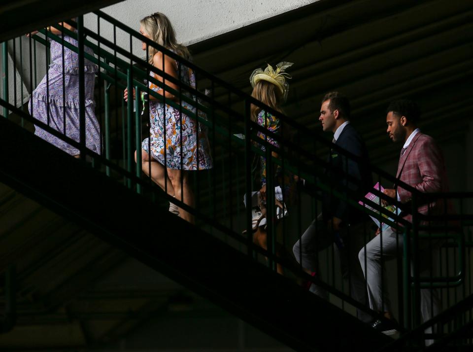 People walk up a set of Grandstand stairs at Churchill Downs on Oaks Day Friday morning. May 6, 2022 May 6, 2022