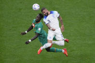 Senegal's Moussa Ndiaye, left, and England's Kyle Walker vie for the ball during the World Cup round of 16 soccer match between England and Senegal, at the Al Bayt Stadium in Al Khor, Qatar, Sunday, Dec. 4, 2022. (AP Photo/Darko Bandic)