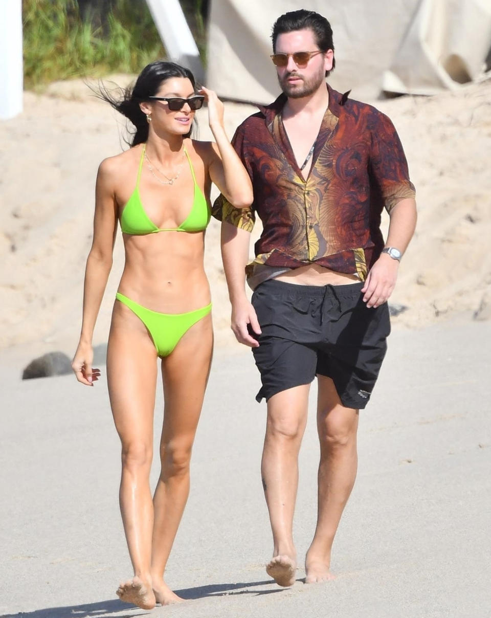 <p>Scott Disick and model Bella Banos take a stroll on the beach in St. Bart's on Dec. 21.</p>