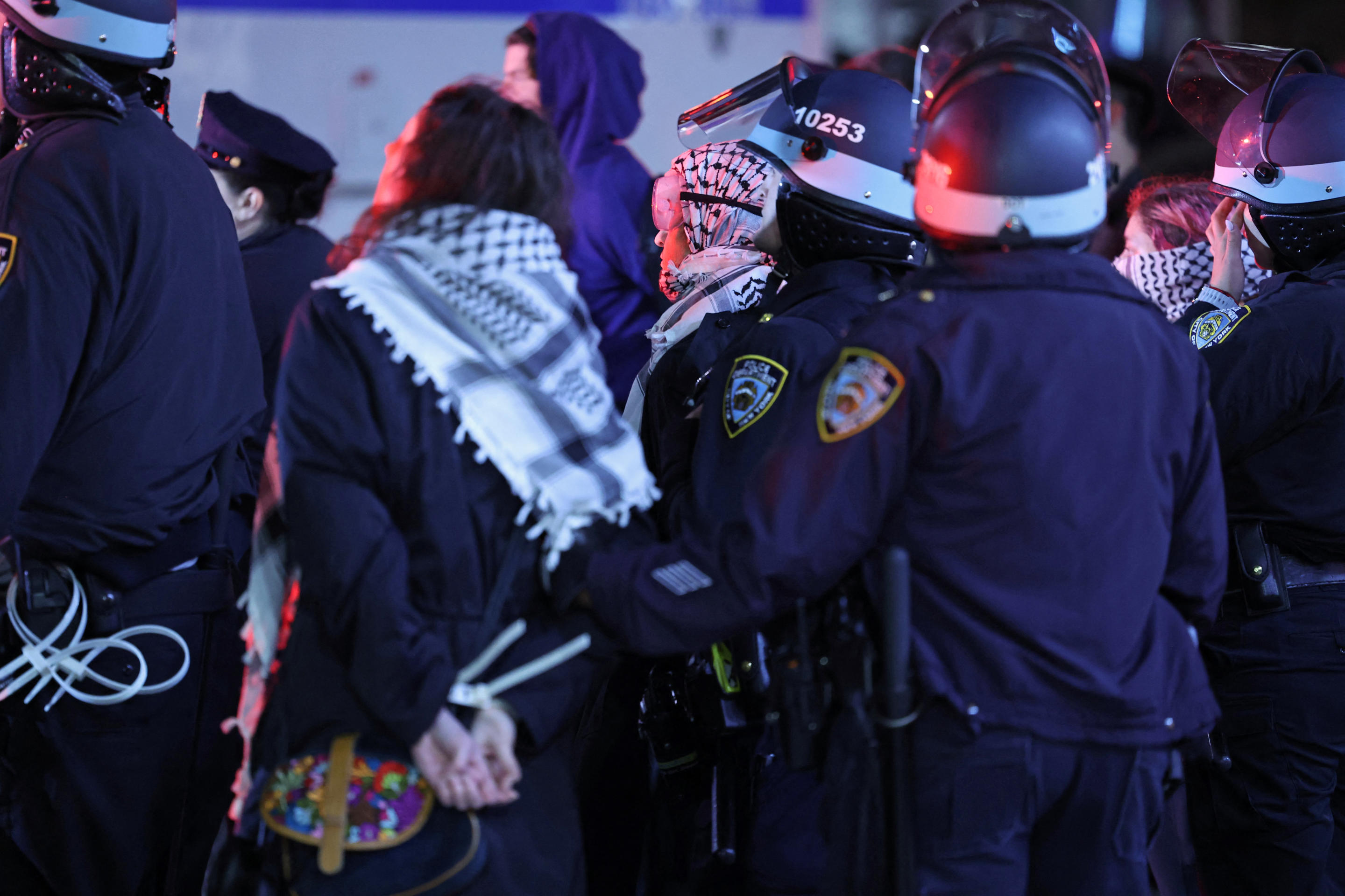 NYPD officers take protesters into custody. 