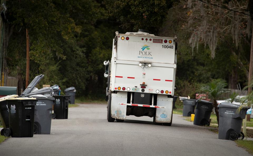 A solid waste hauler picks up trash on Annette Street off Gib Galloway Road. Residents  are upset about lack of garbage pickup and trash accumulating on the side of the road  in Lakeland Fl. Tuesday January 4 ,  2022.  ERNST PETERS/ THE LEDGER