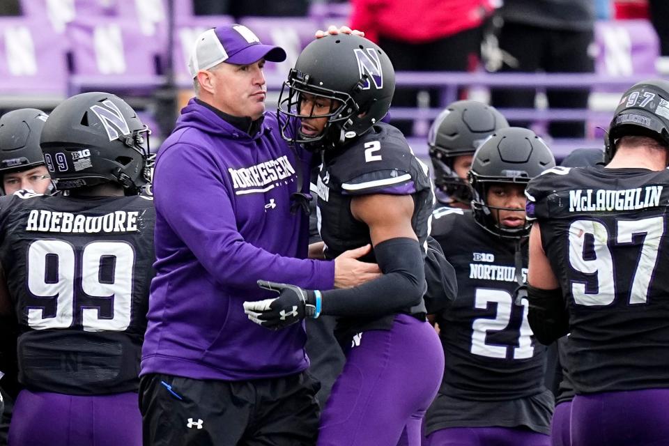 Northwestern coach Pat Fitzgerald hugs defensive back Cameron Mitchell (2) during the second half of visiting Ohio State's 21-7 win on Nov.  5, 2022.