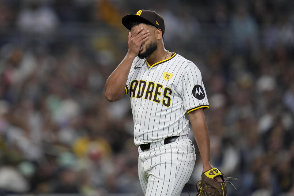 San Diego Padres starting pitcher Randy Vasquez wipes his face after the third out during the fifth inning of a baseball game against the Arizona Diamondbacks, Thursday, June 6, 2024, in San Diego. (AP Photo/Gregory Bull)