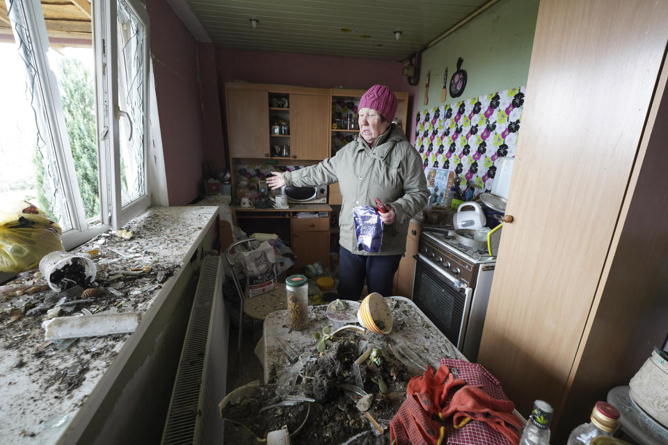 Tetiana Iegorova, 55, shows the kitchen of her house which was damaged by a Russian rocket attack, in Kharkiv, Ukraine, Friday, March 31, 2023. (AP Photo/Andrii Marienko)