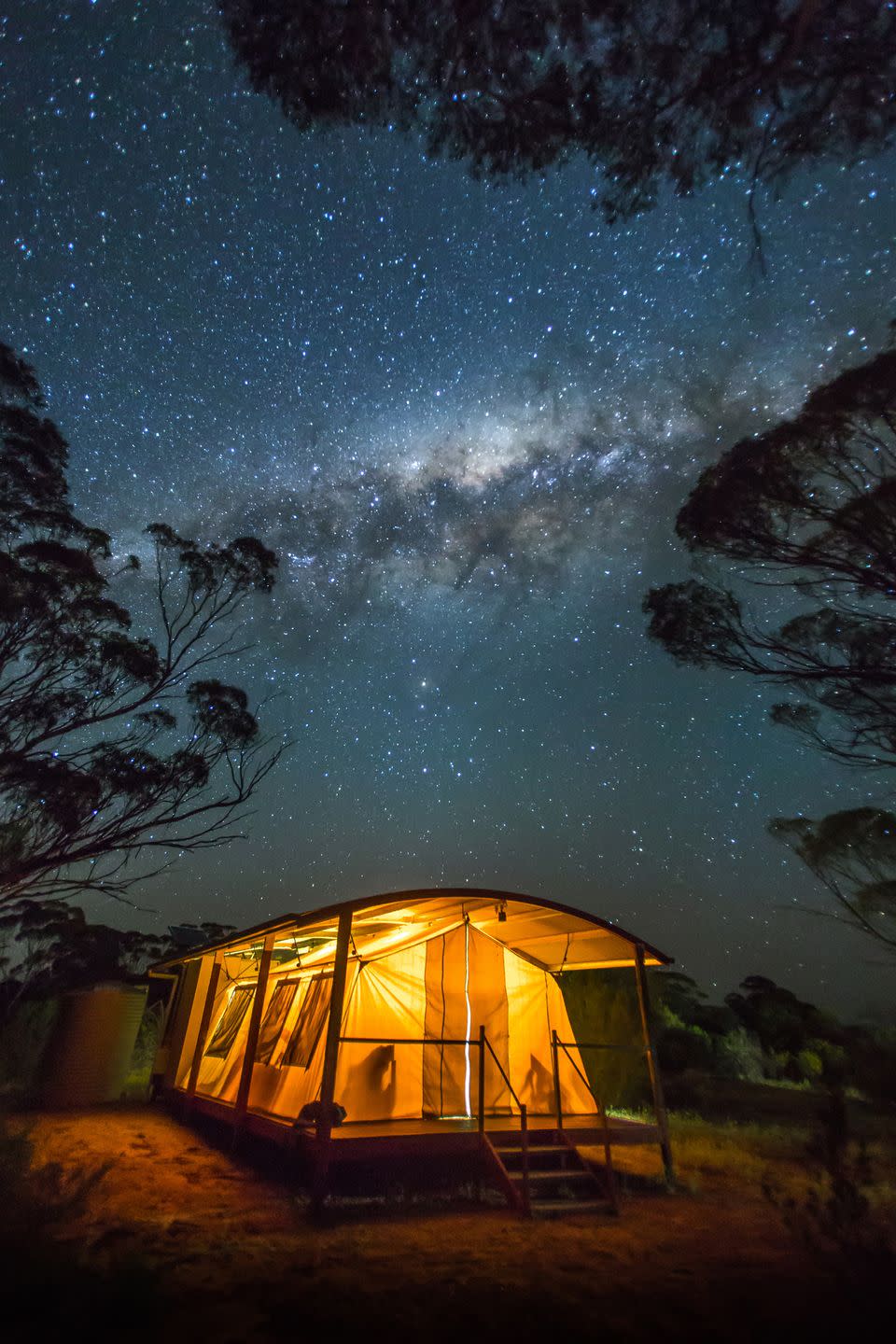 <p>A camper sits under the starry night sky in South Australia.</p>