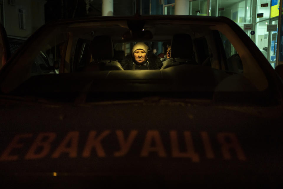 A woman sits in an evacuation bus in Sumy, Ukraine, Thursday, Nov. 23, 2023. An average of 80-120 people return daily to Ukraine from territories held by Russia through an unofficial crossing point between the two countries amid a brutal war. Most choose this challenging path, even in freezing temperatures, to escape Russian occupation and reunite with their relatives in Ukraine. (AP Photo/Hanna Arhirova)