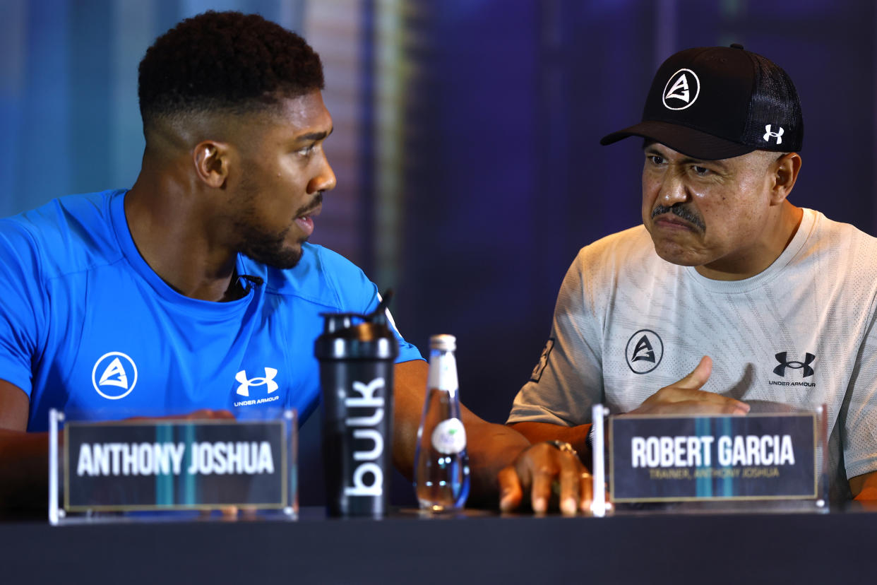 RIYADH, SAUDI ARABIA - AUGUST 17: Anthony Joshua talks with their trainer, Robert Garcia during the Rage on the Red Sea Press Conference at Shangri-La Hotel on August 17, 2022 in Riyadh, Saudi Arabia. (Photo by Francois Nel/Getty Images)