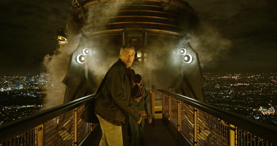 George Clooney walking on a bridge at night