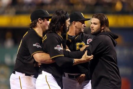 Oct 7, 2015; Pittsburgh, PA, USA; Pittsburgh Pirates first baseman Sean Rodriguez (3) is held back by teammates during an altercation with the Chicago Cubs during the seventh inning in the National League Wild Card playoff baseball game at PNC Park. Rodriguez was ejected from the game. Charles LeClaire-USA TODAY Sports