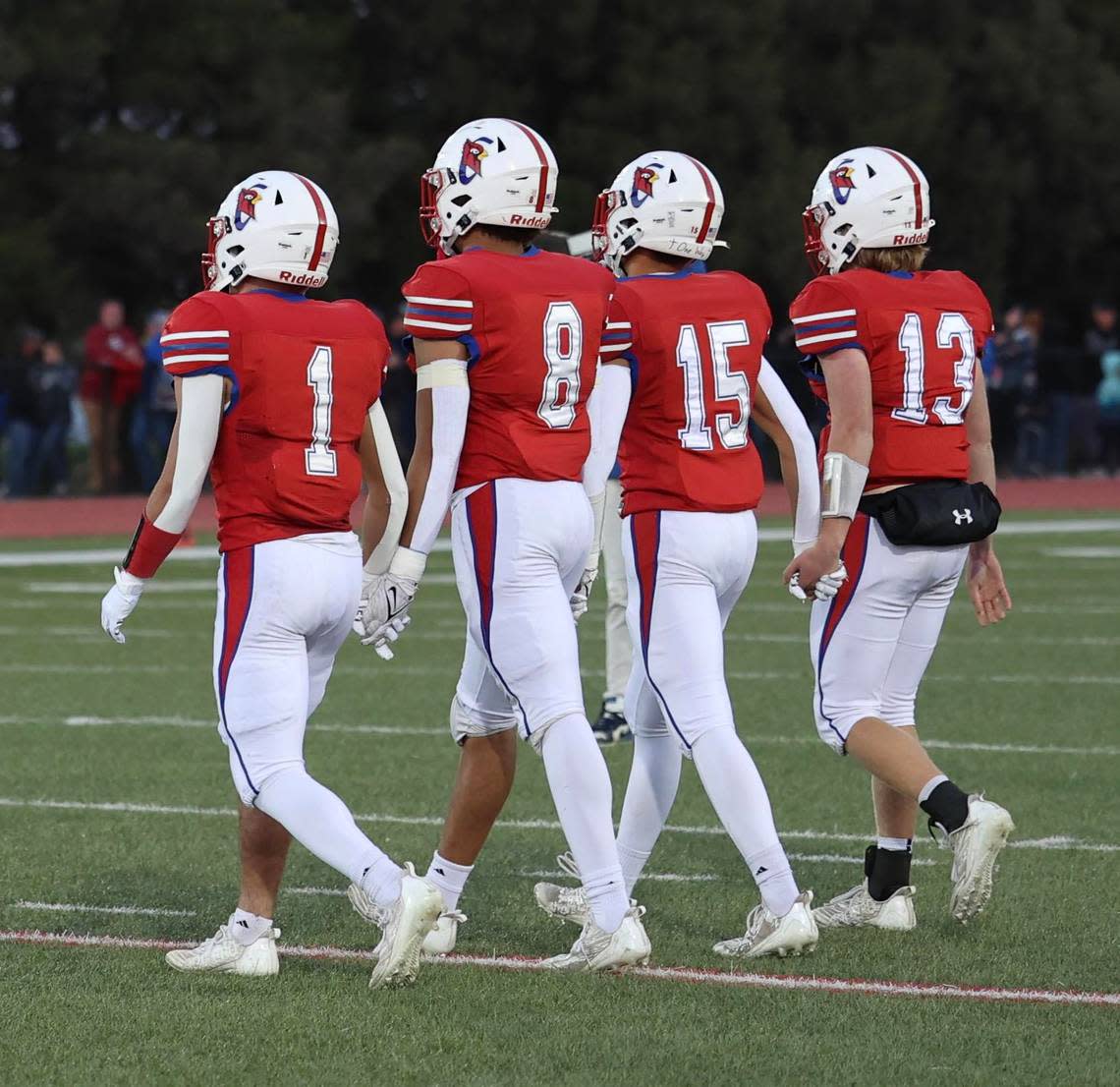 The Cheney senior captains walk onto the field for Friday’s game against Andale.